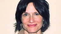 Close photo of a woman's face, smiling.