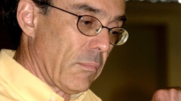 Profile photo of a man at work, thinking.