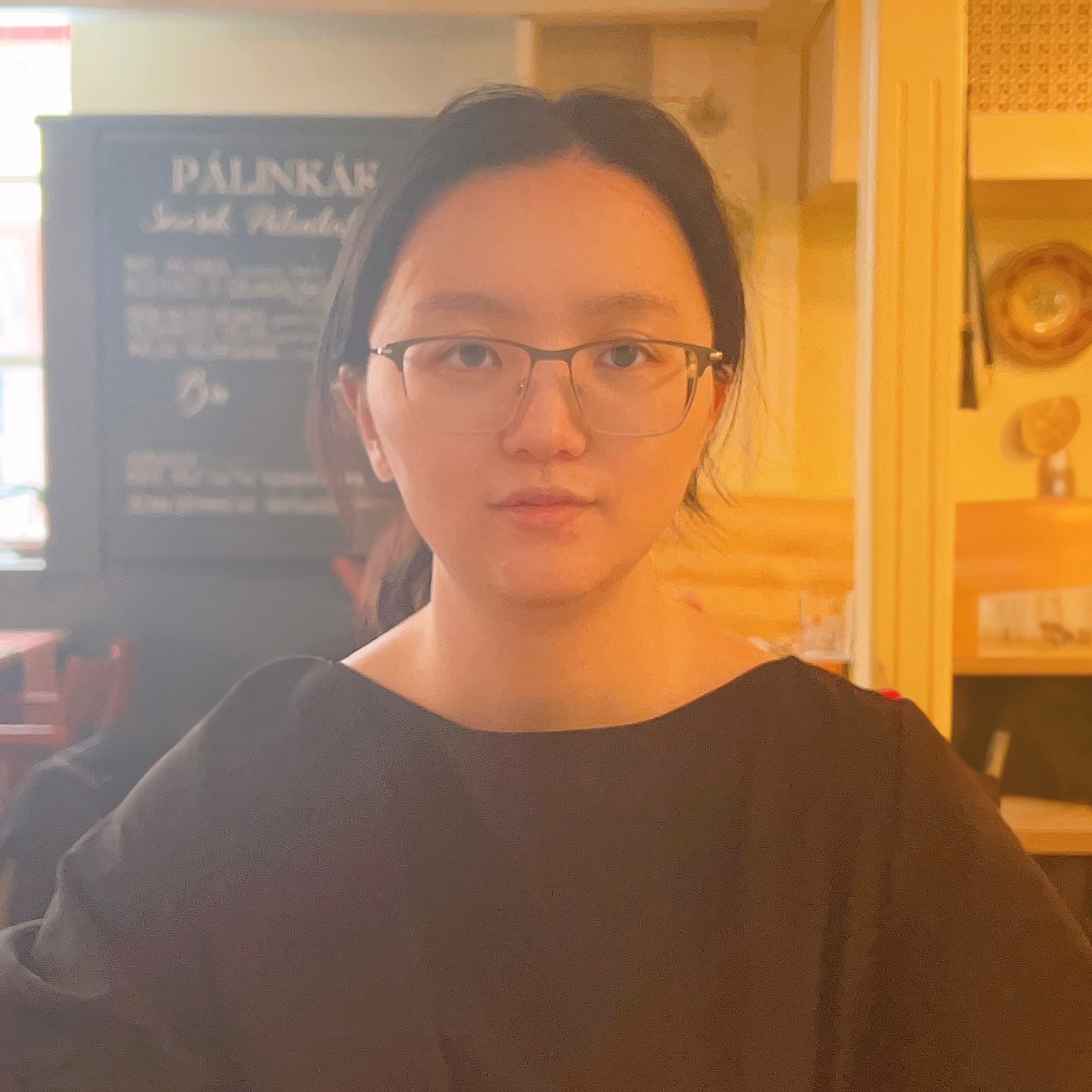 Close portrait of a young woman in a coffee shop.