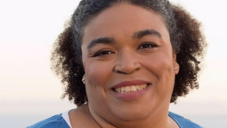 Close portrait of a smiling woman, outside.